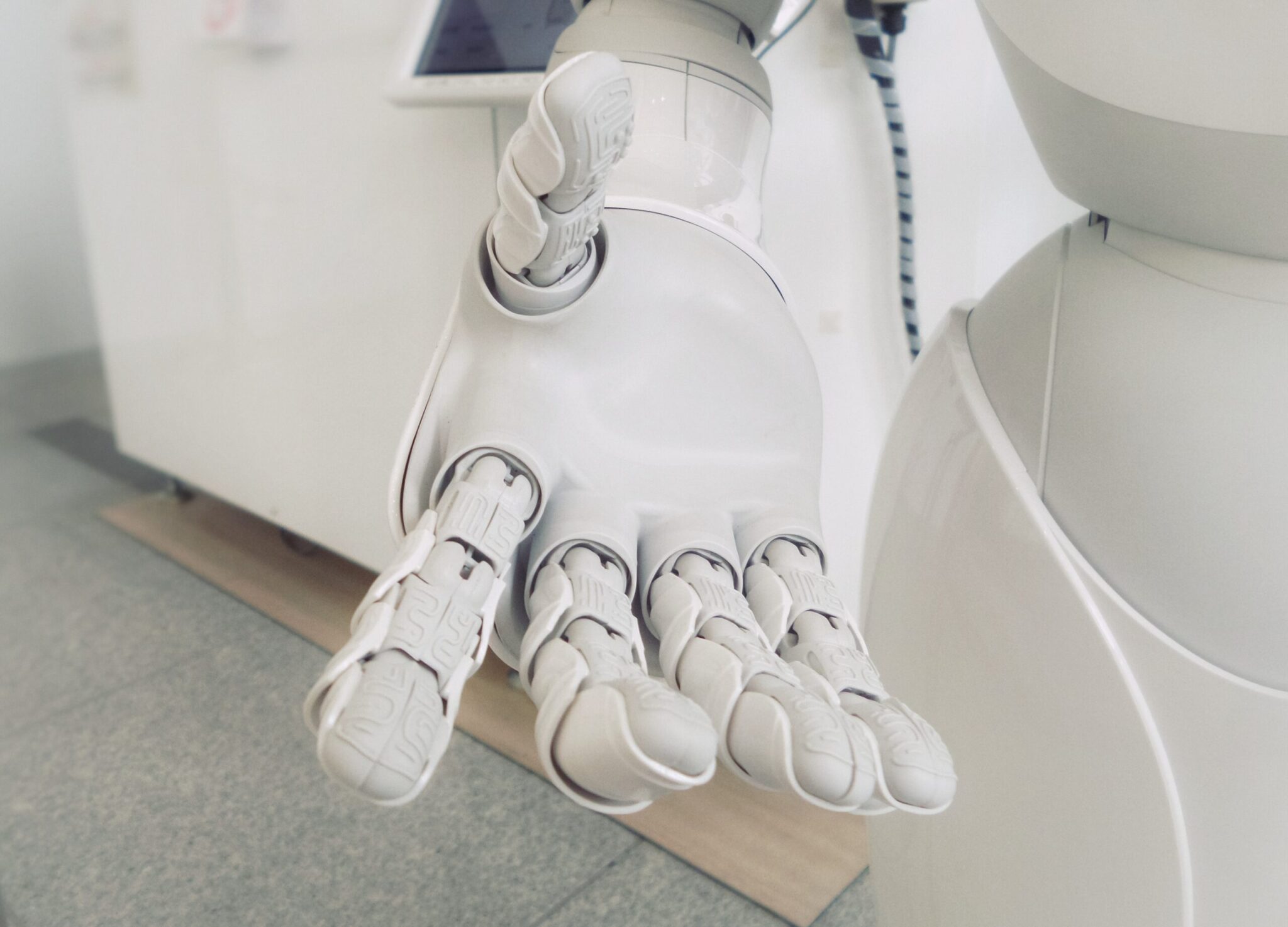 The Artificial Intelligence RenAIssance is at hand- shown by an advanced cybernetic holding out a welcoming hand.